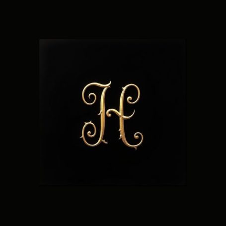 Black notebook cover with a fancy gold capital letter H