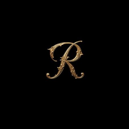 Black notebook cover with a fancy gold capital letter R